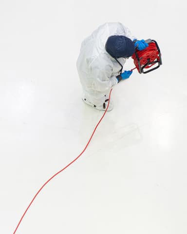 Quality Assurance engineer Lucinda Taylor unreels a power cord across the cleanroom floor at Goddard Space Flight Center, Greenbelt Md., April 21, 2025